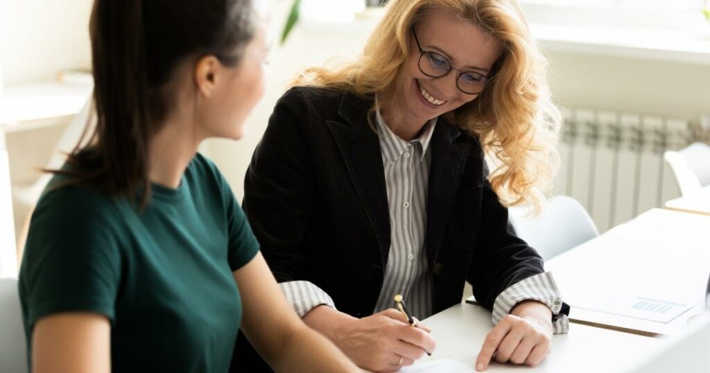 a smiling HR coordinator interacting with new team member