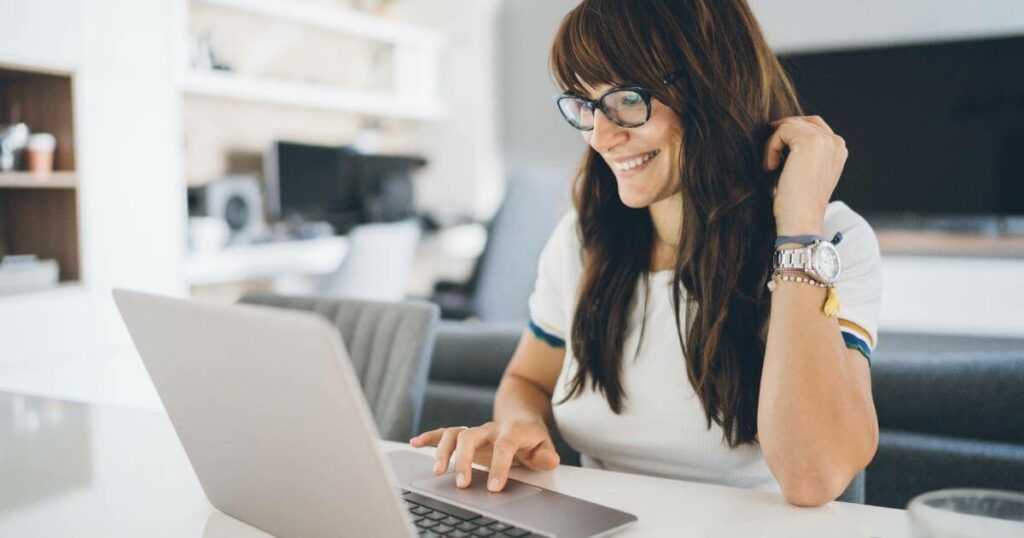 woman working remotely from home on laptop