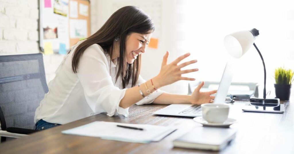 frustrated professional frowning at laptop