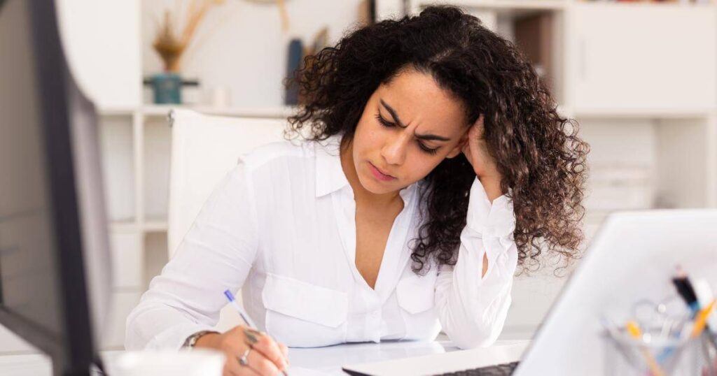 frustrated hr person writing notes about TA challenges