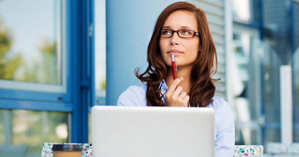 woman sitting in front of laptop thinking about what to write