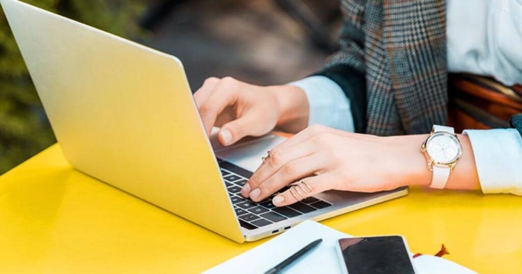 closeup of professional typing on laptop