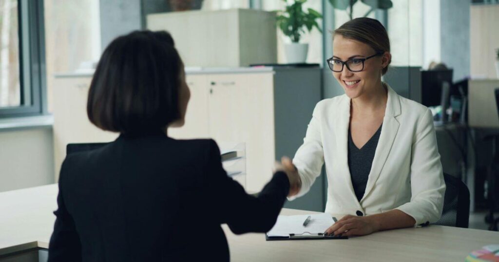 employer shaking hands with recruiter after discussing ap/ar hiring needs